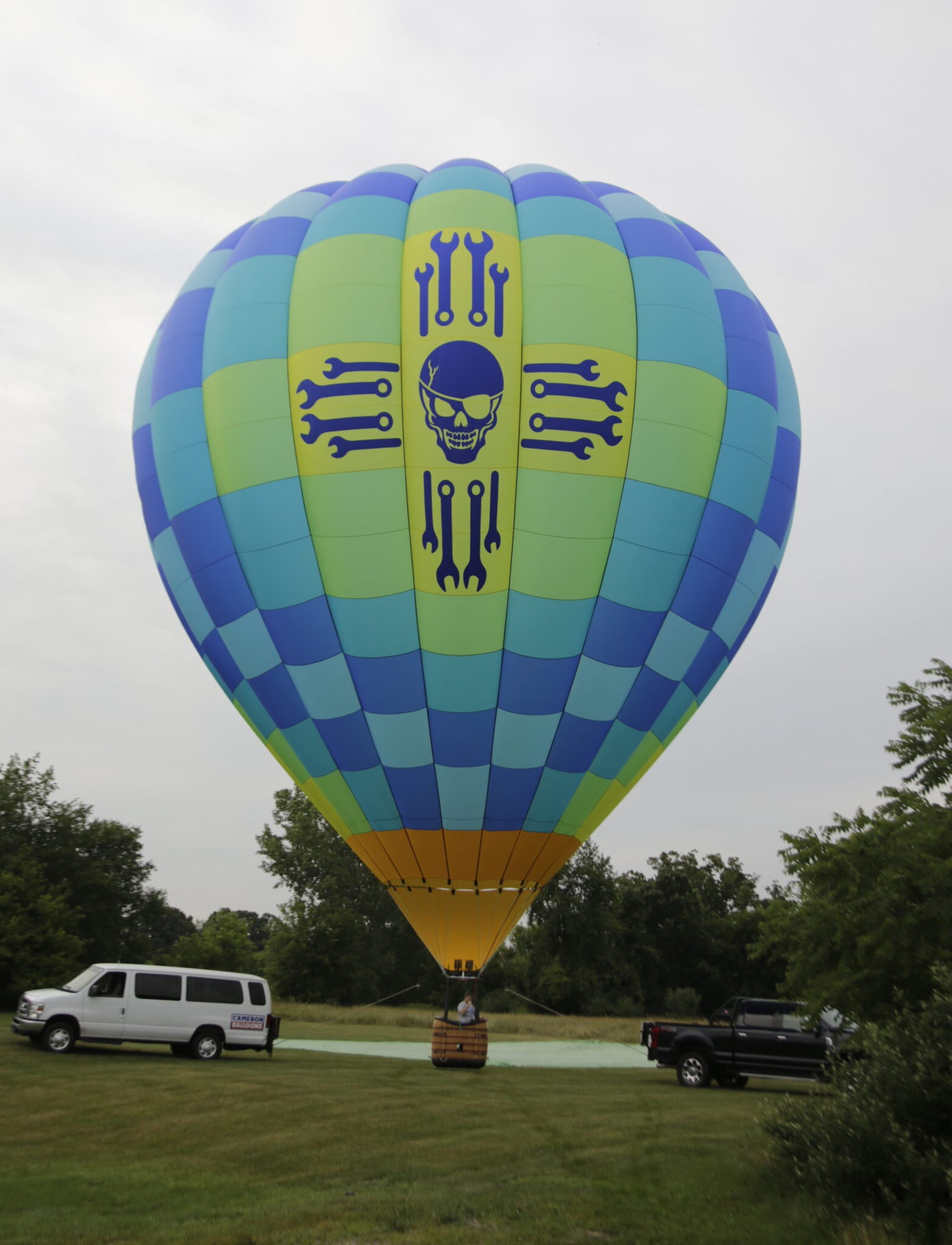 Cameron A-105 hot air balloon on ground with a cloudy sky