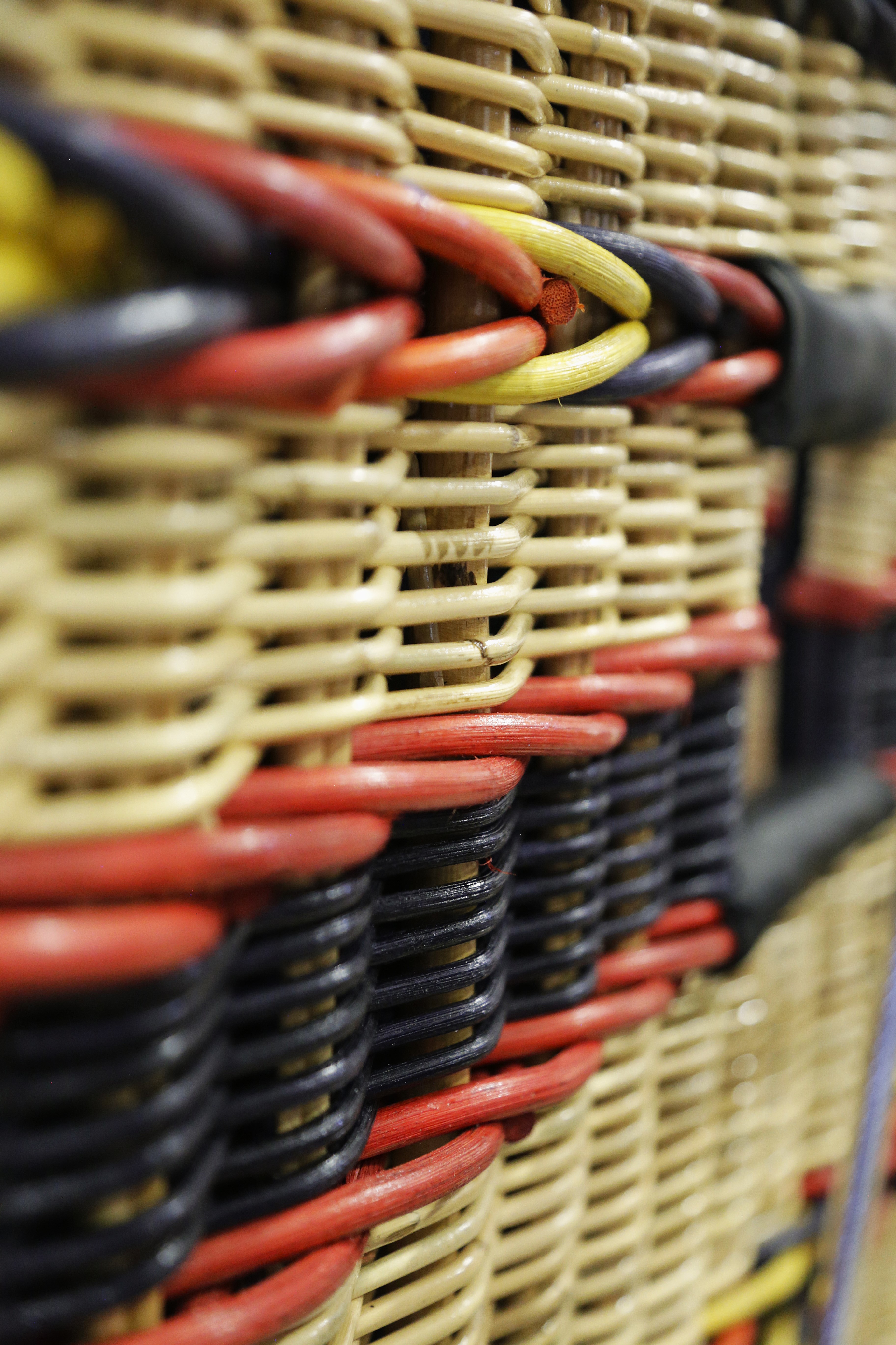 Detailed photo of red, orange, yellow & navy accent weave on a Cameron Aristocrat hot air balloon basket