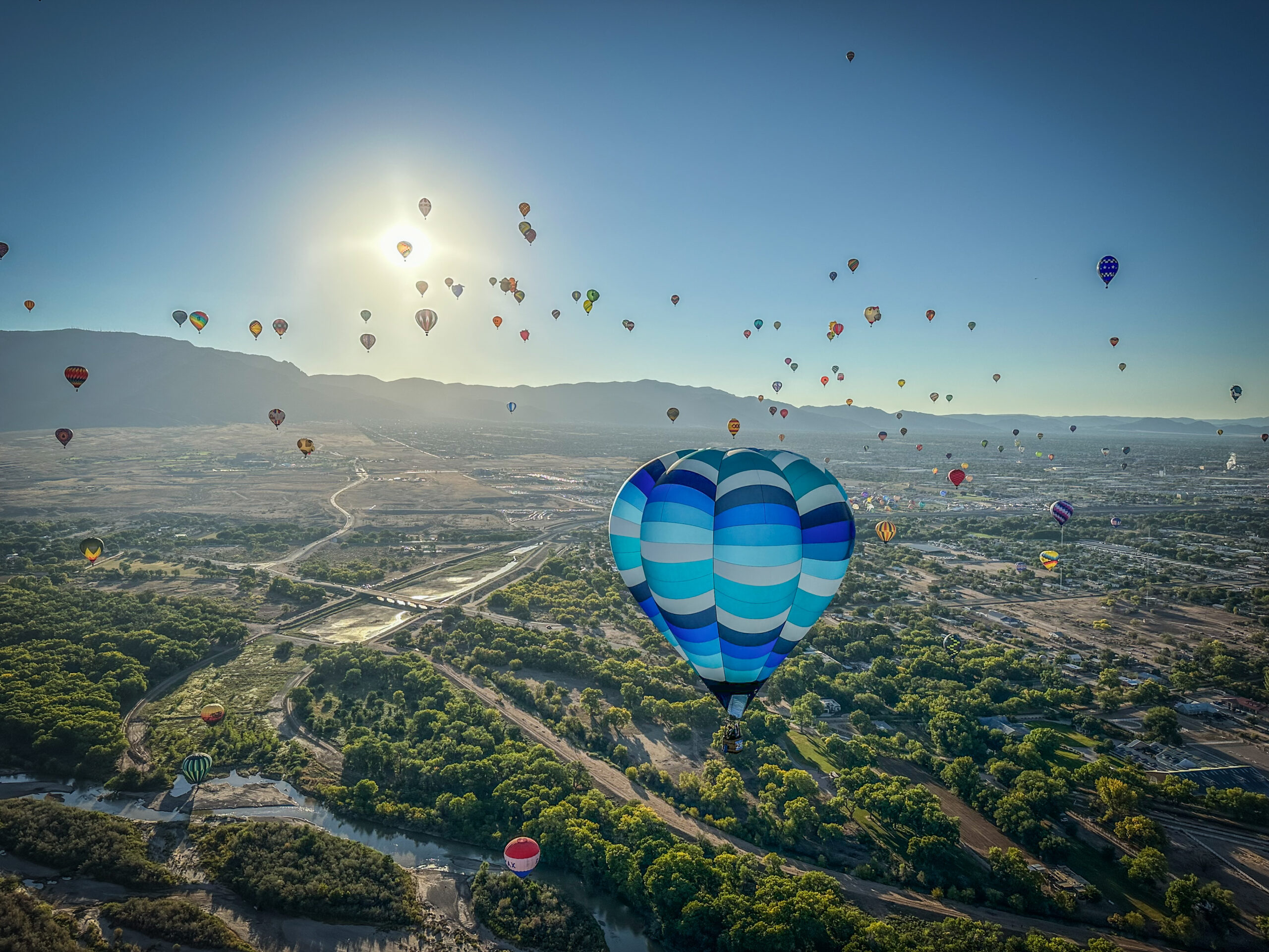 Cameron V-90 hot air balloon in flight above the Rio Grande in Albuquerque
