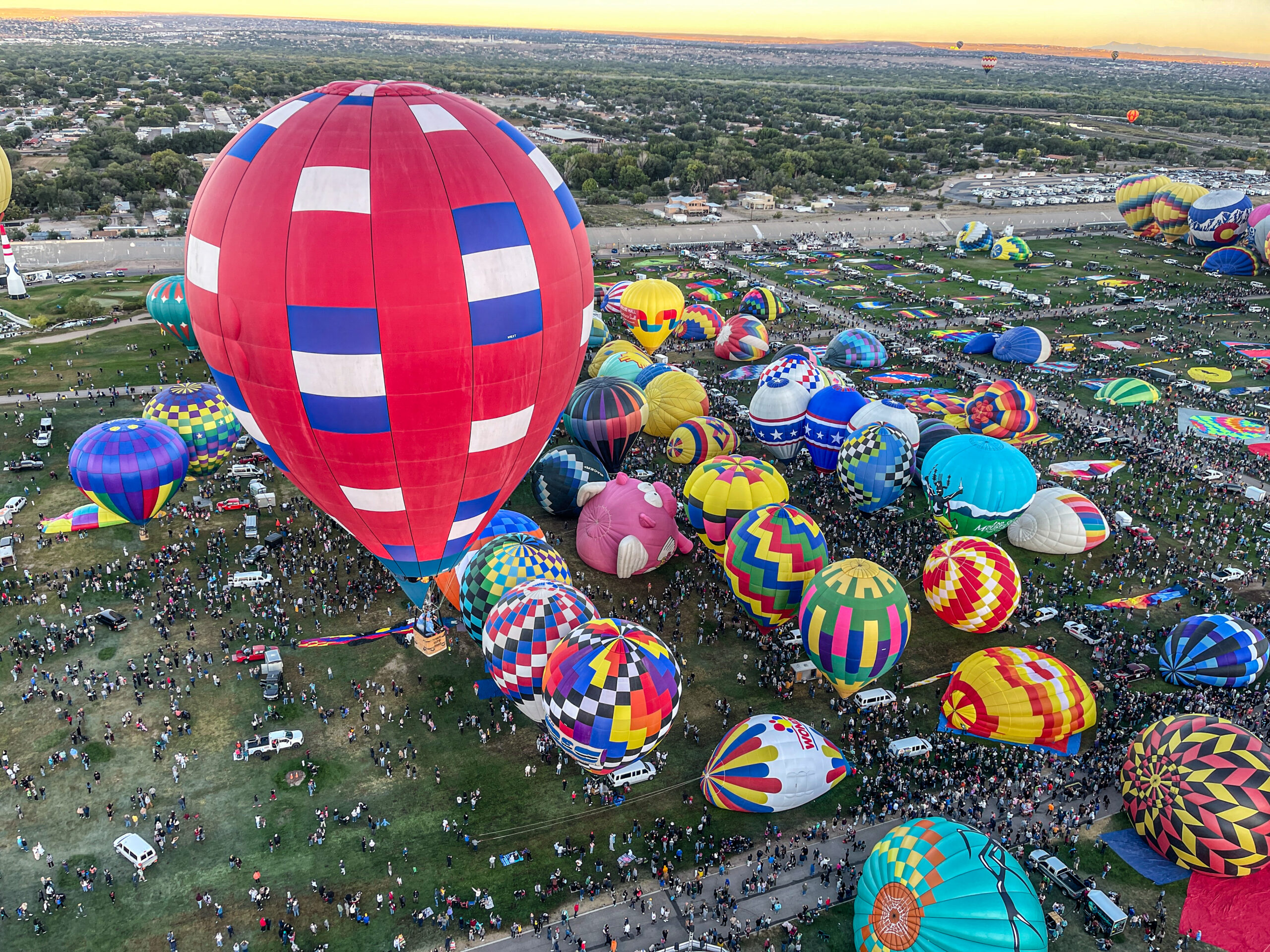 Cameron XT-65 hot air balloon taking off amongst dozens of other balloons at the Albuquerque International Balloon Fiesta
