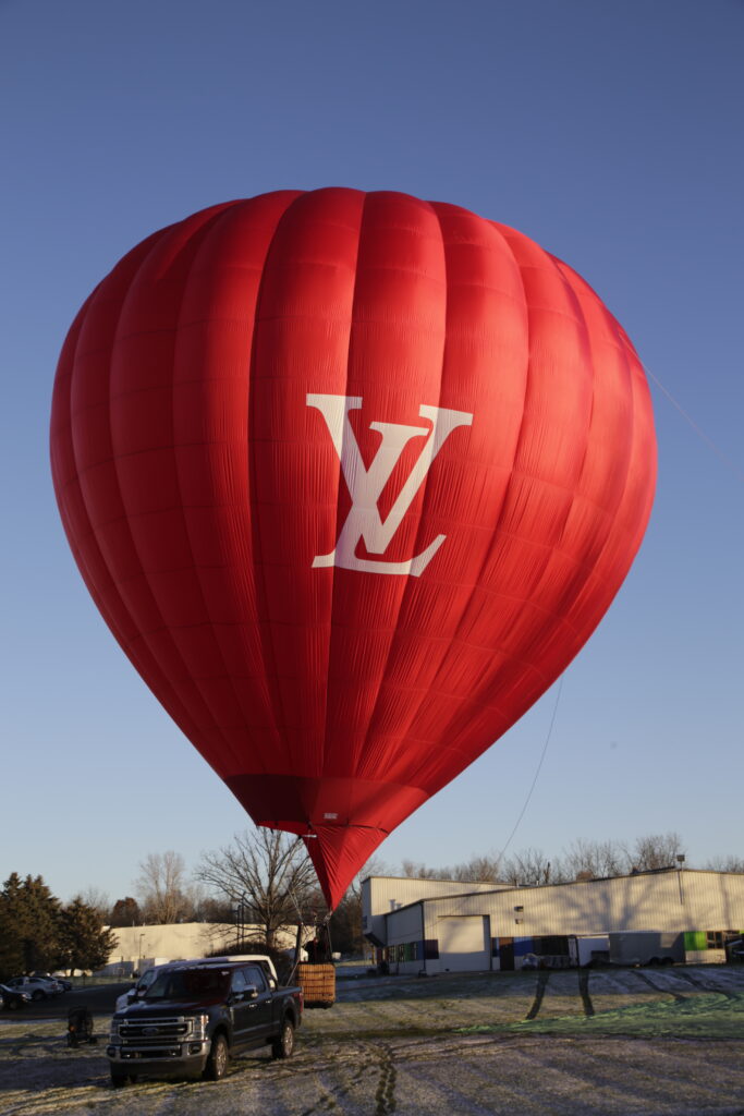 Cameron Z-90 hot air balloon with Louis Vuitton custom branding on ground