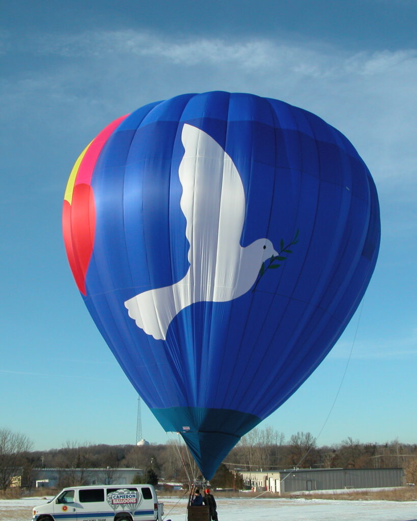 Cameron N-90 hot air balloon with large artwork of a white dove and heart with a rainbow