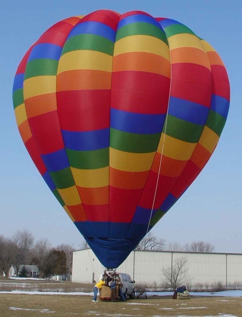 Cameron O-84 hot air balloon on ground with melting snow
