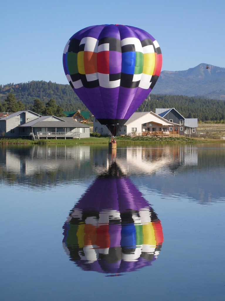 Cameron O-90 hot air balloon touching the surface of a Colorado lake