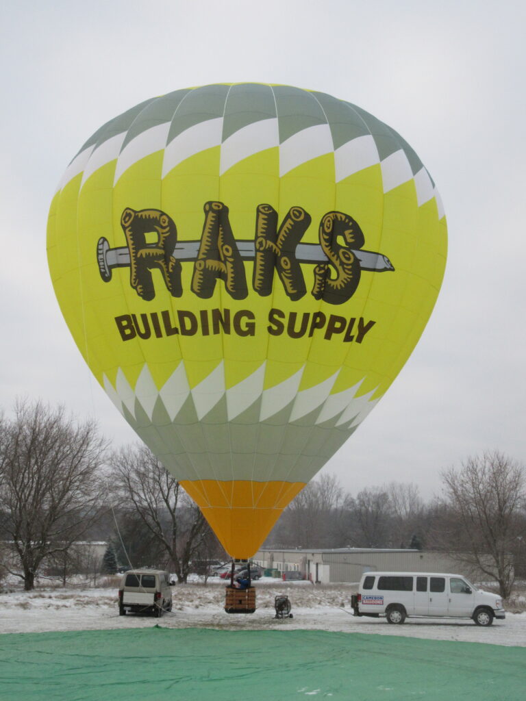 Cameron Z-105 hot air balloon on ground with Raks Building Supply custom branding