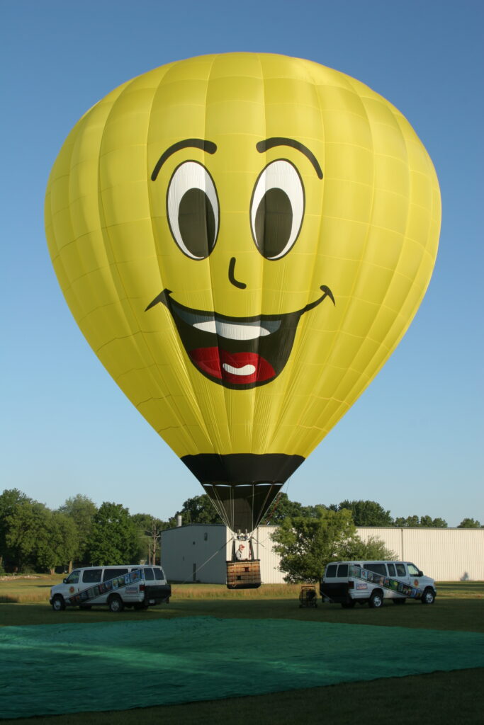 Appliqued and inlayed smiley face artwork on a Cameron Z-type hot air balloon