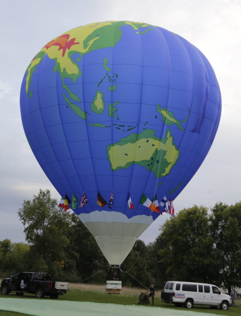 Cameron Z-105 hot air balloon with custom world map artwork on ground