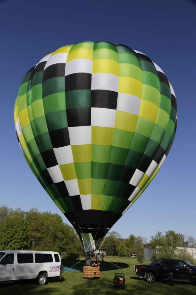 Cameron Z-105 hot air balloon on ground with bright green color pattern