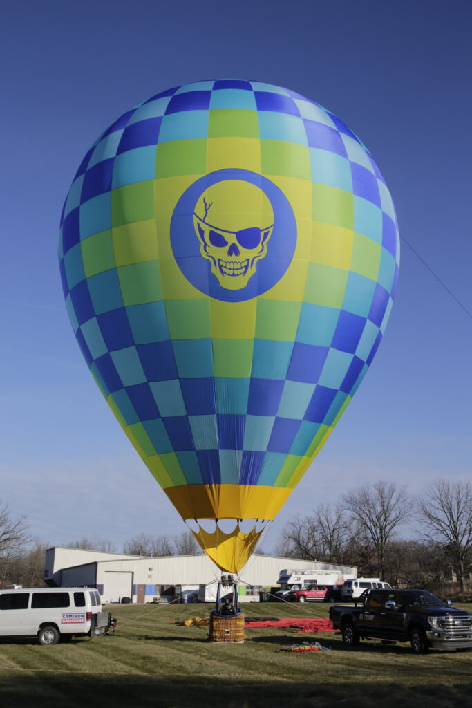 Cameron ZL-65 racer hot air balloon with custom skull artwork on ground