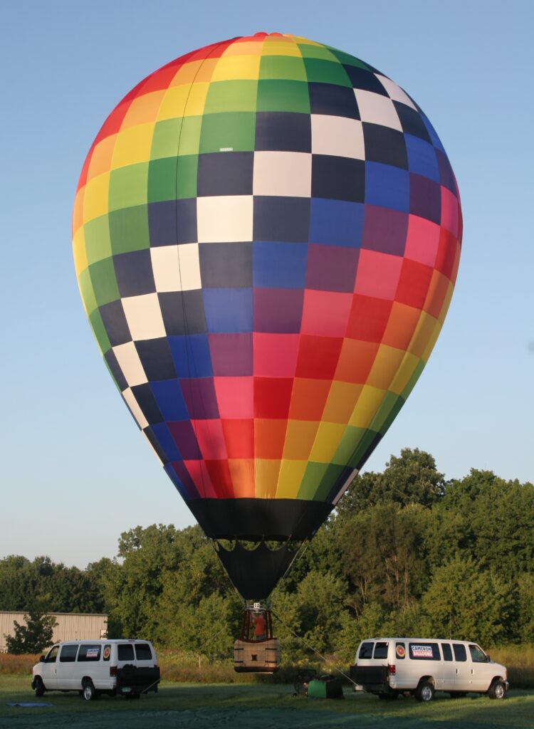 Cameron ZL-60 racer hot air balloon tethered in summertime