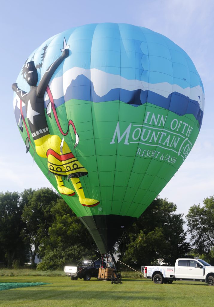 Cameron Z-105 hot air balloon with custom Inn of the Mountain Gods branding, appendages, & hanging feathers