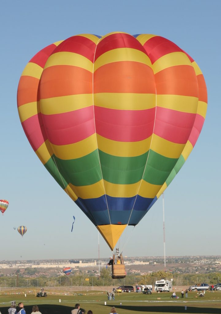 Cameron V-77 hot air balloon flying to a target over Albuquerque