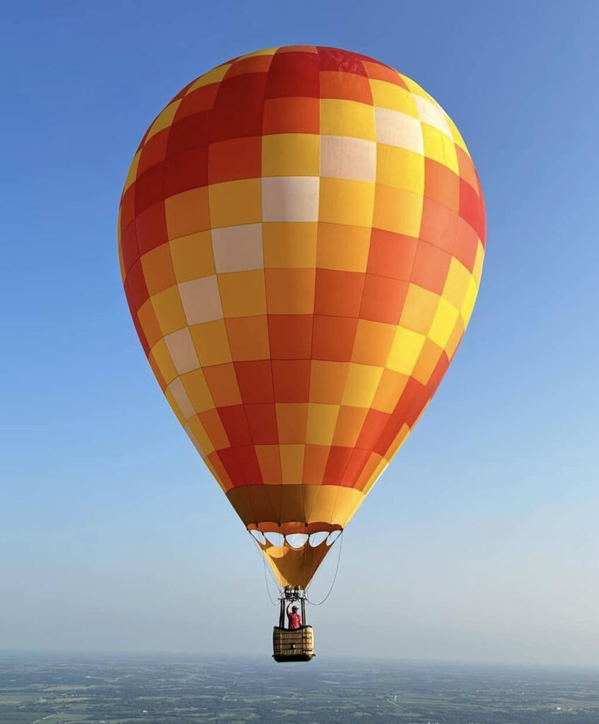 Cameron ZL-65 racer hot air balloon in flight over Indianola, Iowa